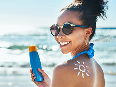 Young woman with a sunscreen cream